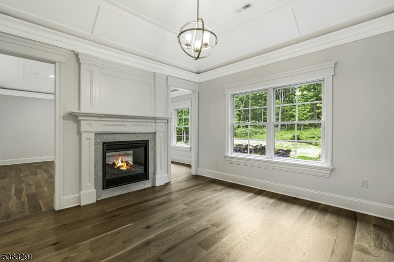 8 Cobblestone Court Warren, NJ 07059 - Photo 36 of 50 a view of an empty room with wooden floor fireplace and a window