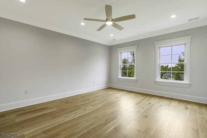 8 Cobblestone Court Warren, NJ 07059 - Photo 43 of 50 a view of an empty room with a window and wooden floor