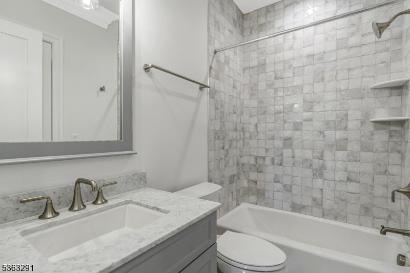 8 Cobblestone Court Warren, NJ 07059 - Photo 45 of 50 a bathroom with a granite countertop bathtub shower sink vanity mirror and toilet