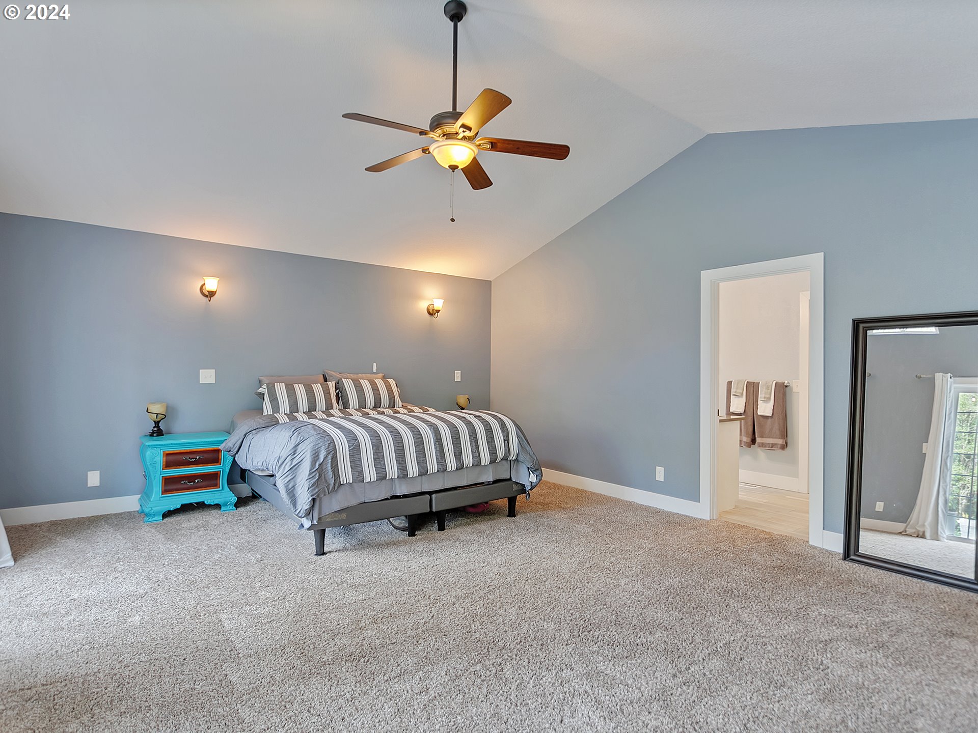 40209 Southeast Fish Hatchery Road Sandy, OR 97055 - Photo 18 of 48 a spacious bedroom with a bed and a chandelier