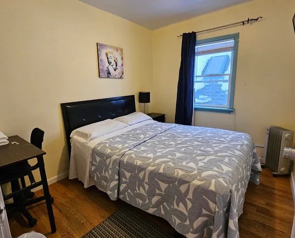 a bedroom with a bed and a window