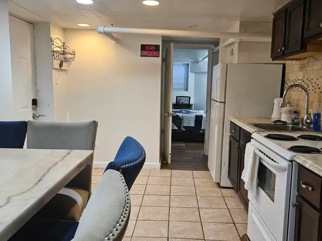 a kitchen with stainless steel appliances a stove a refrigerator and cabinets