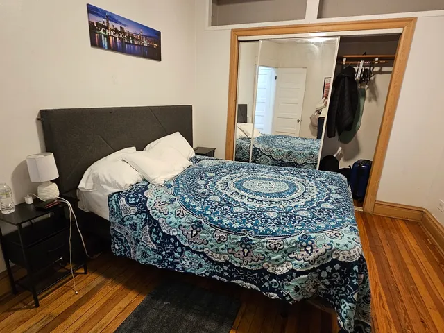 a bedroom with a bed and dresser