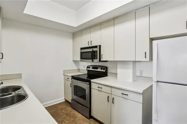 a kitchen with a sink and a stove top oven