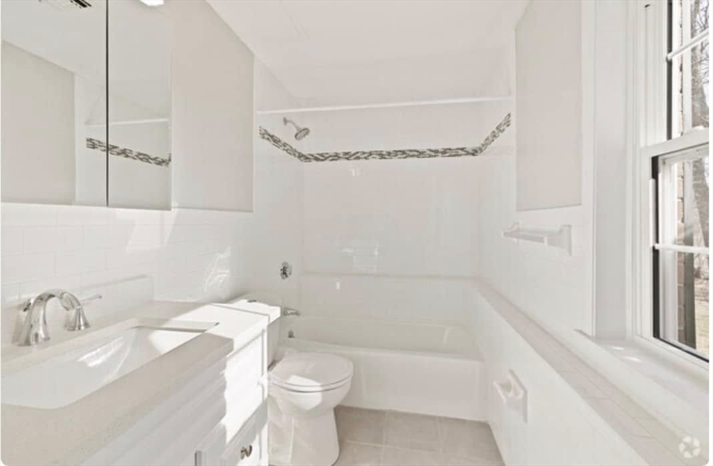 200 Bedford Road, Unit 7E Woburn, MA 01801 - Photo 4 of 14 a bathroom with a sink toilet and shower