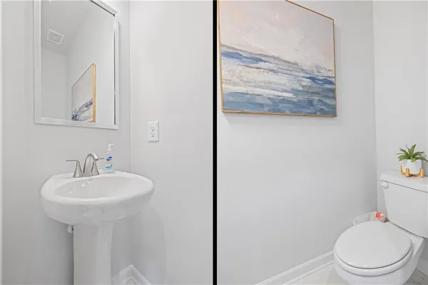 a bathroom with a sink mirror and toilet