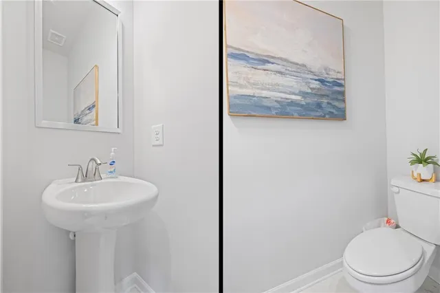 a bathroom with a sink mirror and toilet