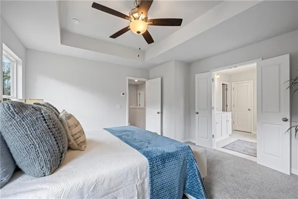 a bedroom with a large bed and a chandelier