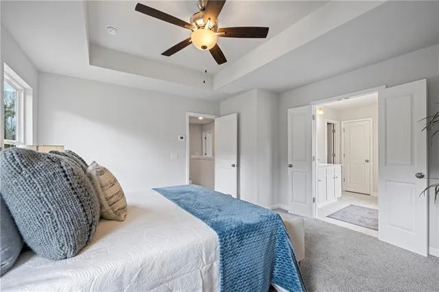 a bedroom with a large bed and a chandelier