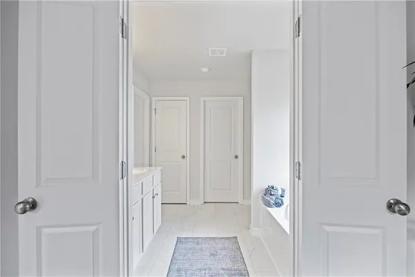 a view of a hallway with white doors