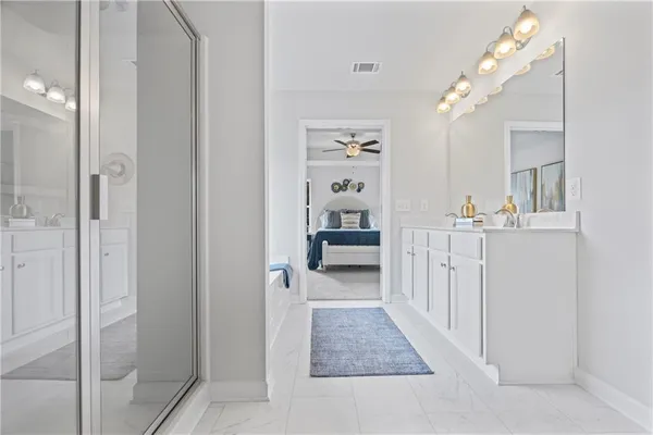 a bathroom with a double vanity sink mirror and shower