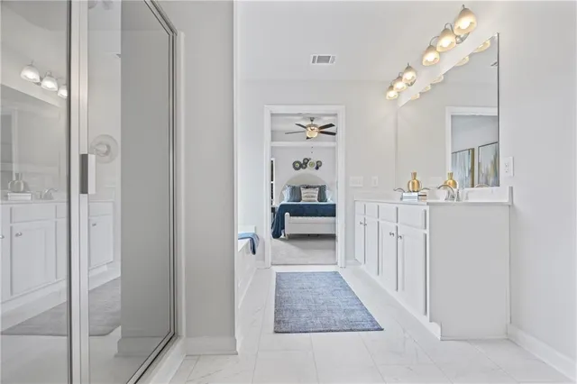 a bathroom with a double vanity sink mirror and shower