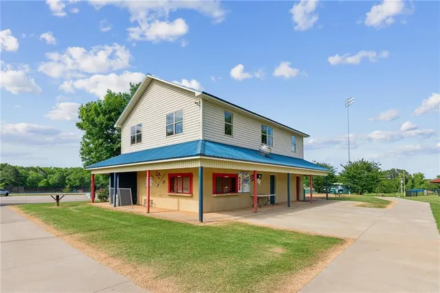 a view of house with yard and entertaining space