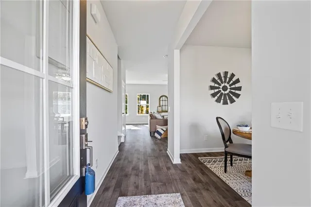 a hallway with furniture and wooden floor
