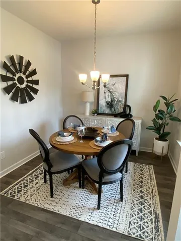 a dining room with furniture and wooden floor