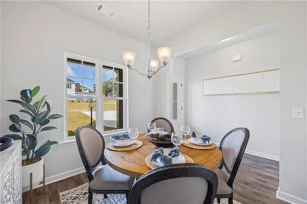 a dining room with furniture and wooden floor
