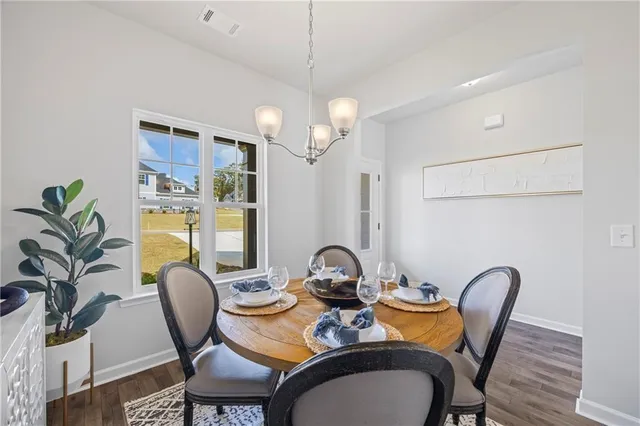 a dining room with furniture and wooden floor