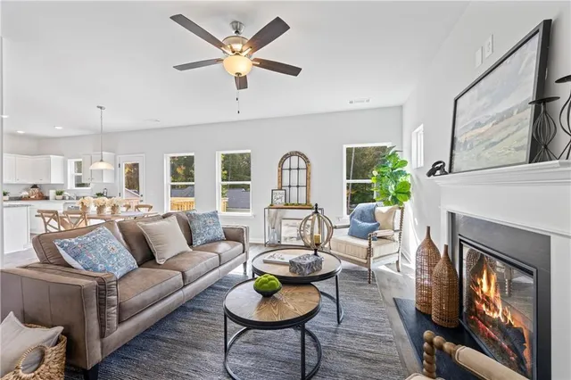 a living room with furniture kitchen view and a fireplace
