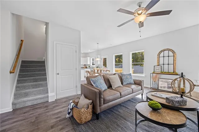 a living room with furniture and a wooden floor
