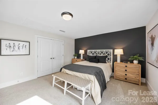 a bedroom with a bed and a lamp