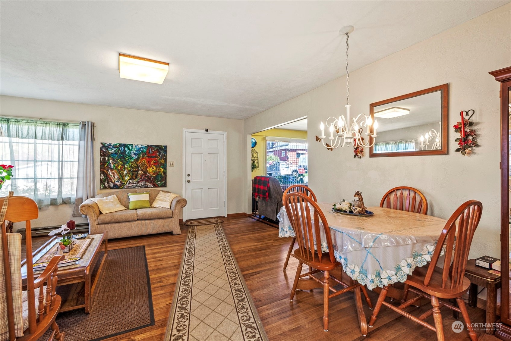 502 Burcham Street Kelso, WA 98626 - Photo 15 of 38 a view of a dining room with furniture a chandelier and wooden floor