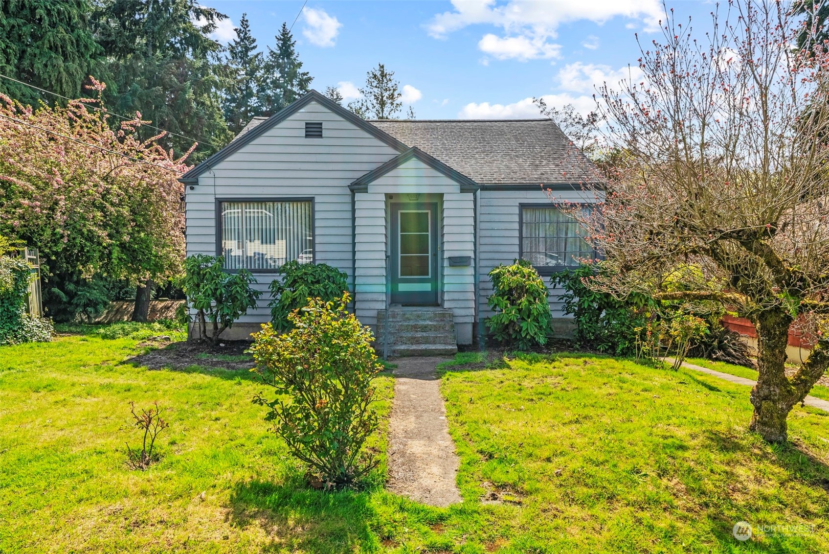 502 Burcham Street Kelso, WA 98626 - Photo 2 of 38 a yellow house with trees in front of it