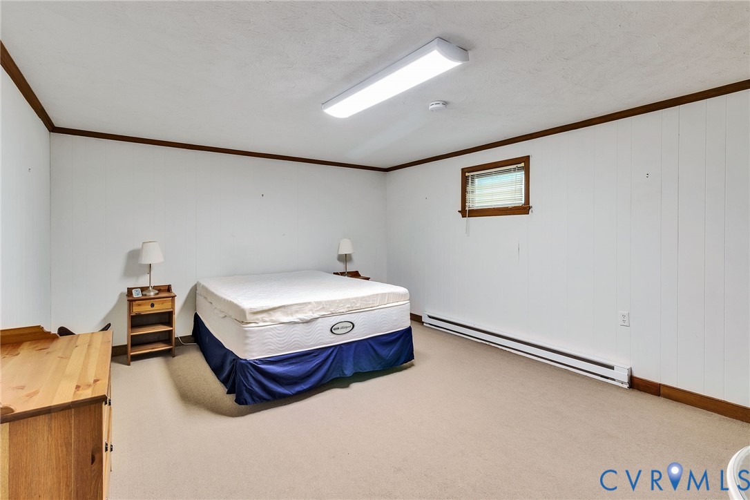 142 Bridge Lane Reedville, VA 22539 - Photo 17 of 56 a bedroom with a bed and a table in it