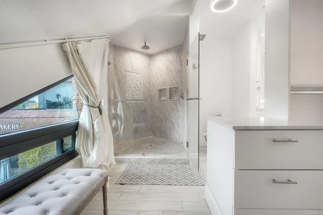 a bathroom with a shower and a tub