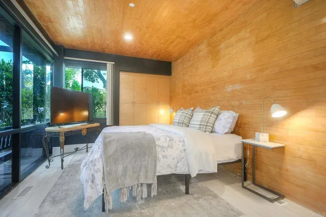 a bedroom with a bed and large window