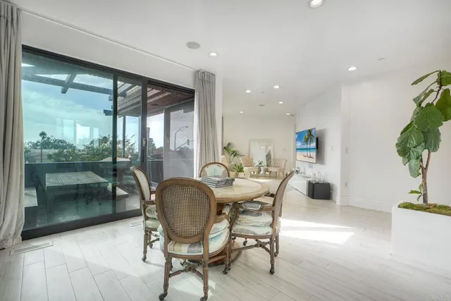 a dining room with furniture wooden floor and a potted plant