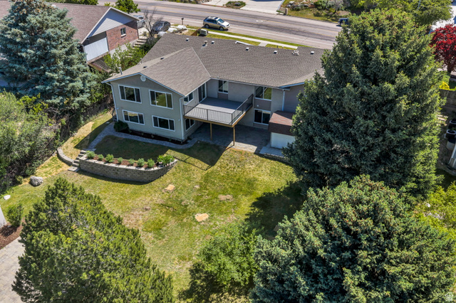 3813 North Foothill Drive Provo, UT 84604 - Photo 61 of 71 Exterior featuring a multi-level deck, lower patio, and a stone retaining wall with plantings