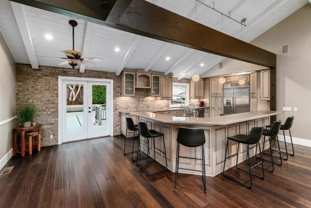 a large kitchen with stainless steel appliances granite countertop a stove and a sink
