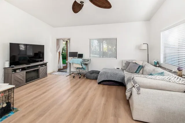 a view of a porch with wooden floor and outdoor seating