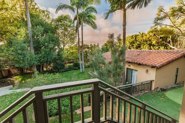a roof deck with couch and wooden floor