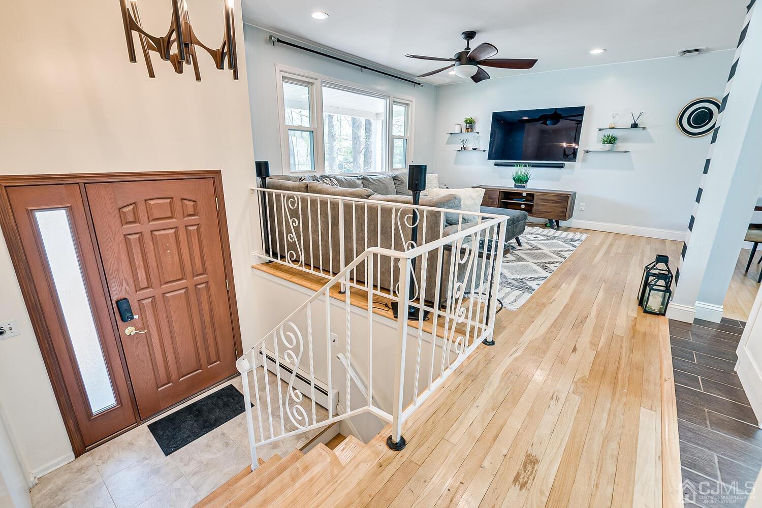 20 Homestead Road Metuchen, NJ 08840 - Photo 11 of 49 a view of a livingroom with furniture a flat screen tv wooden floor and windows