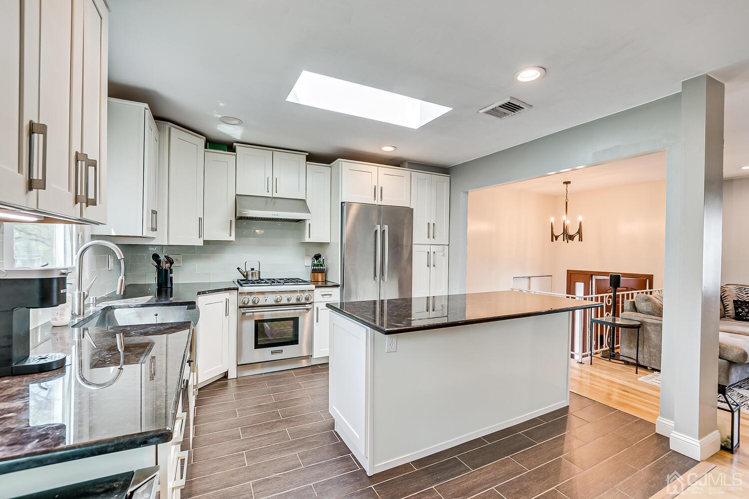 20 Homestead Road Metuchen, NJ 08840 - Photo 21 of 49 a kitchen with stainless steel appliances granite countertop a stove a sink and a refrigerator