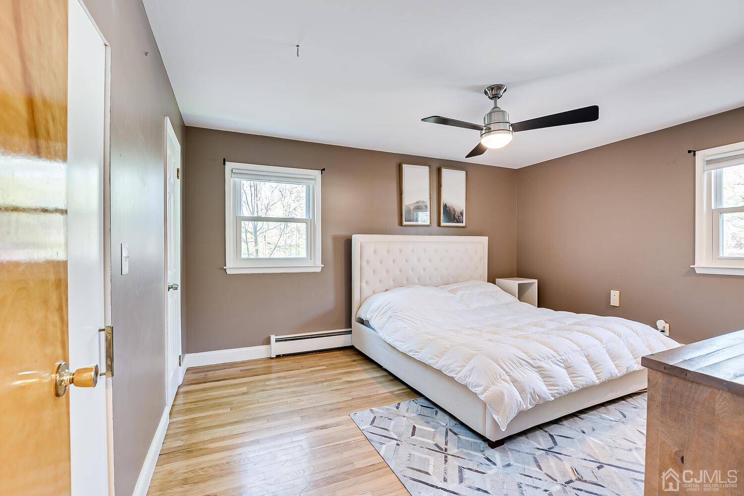 20 Homestead Road Metuchen, NJ 08840 - Photo 23 of 49 a bedroom with a large bed chandelier and a window