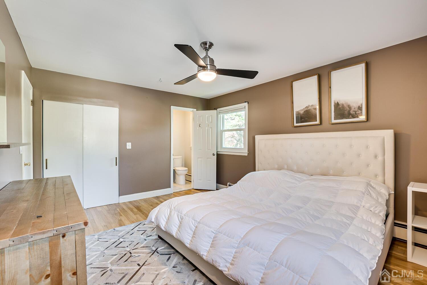 20 Homestead Road Metuchen, NJ 08840 - Photo 24 of 49 a bedroom with a large bed and a chandelier