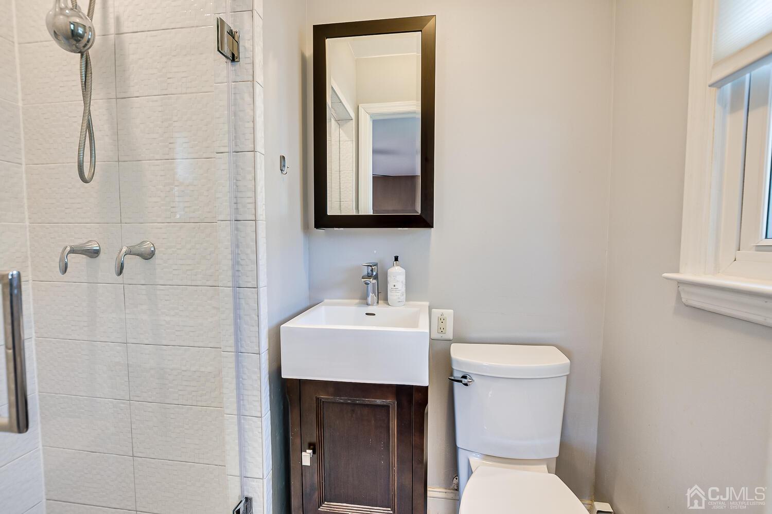 20 Homestead Road Metuchen, NJ 08840 - Photo 25 of 49 a bathroom with a toilet sink vanity and mirror