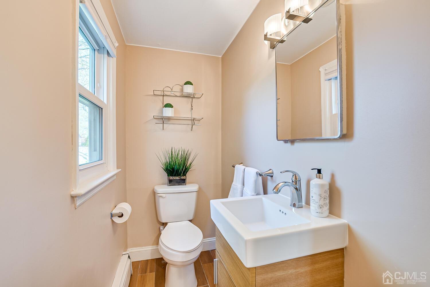 20 Homestead Road Metuchen, NJ 08840 - Photo 33 of 49 a bathroom with a sink toilet and a mirror