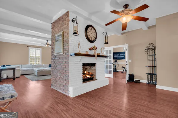 a living room with hard wood floor and a table