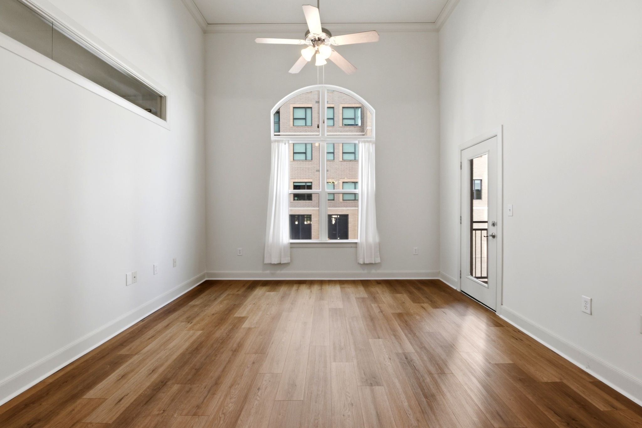 1010 Rosine Street, Unit 43 Houston, TX 77019 - Photo 24 of 48 an empty room with wooden floor chandelier fan and windows