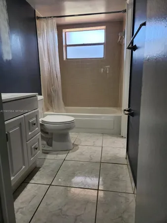a bathroom with a toilet a sink and bathtub
