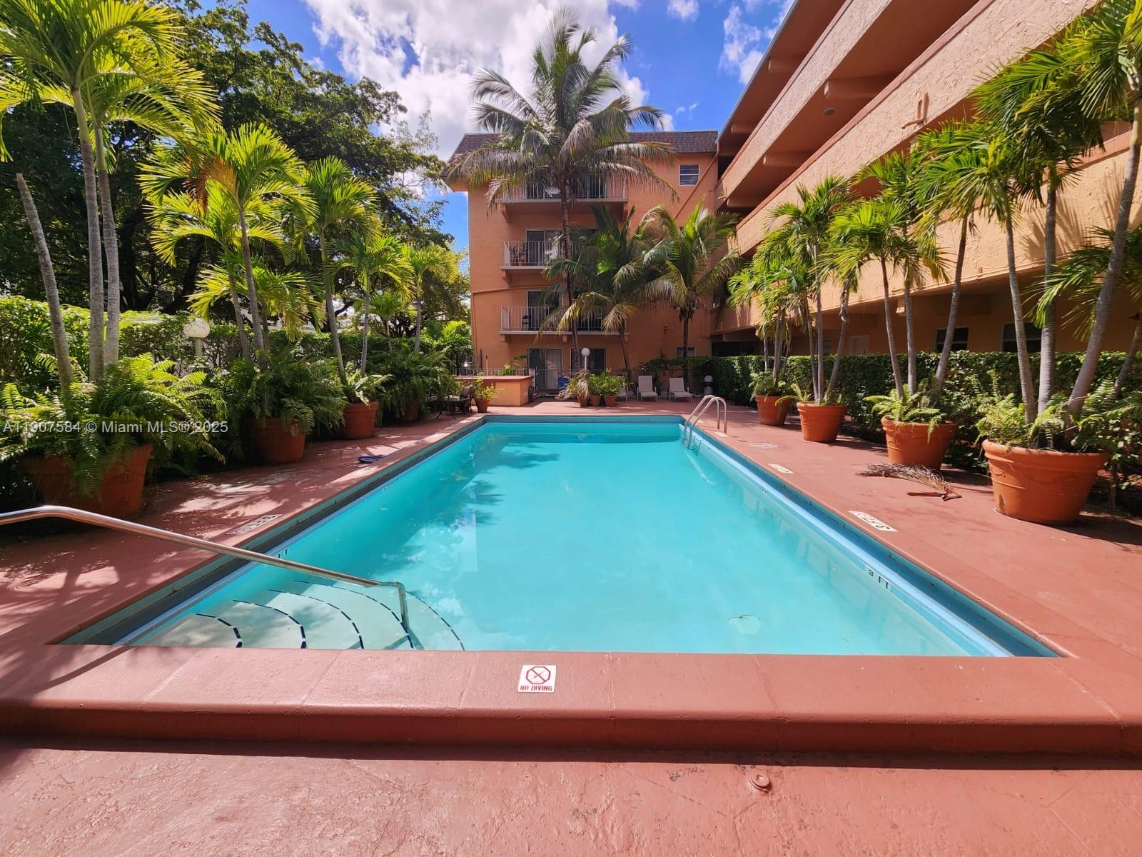 8101 Southwest 73rd Avenue, Unit 30 Miami, FL 33143 - Photo 10 of 14 a wooden bench sitting in front of a building