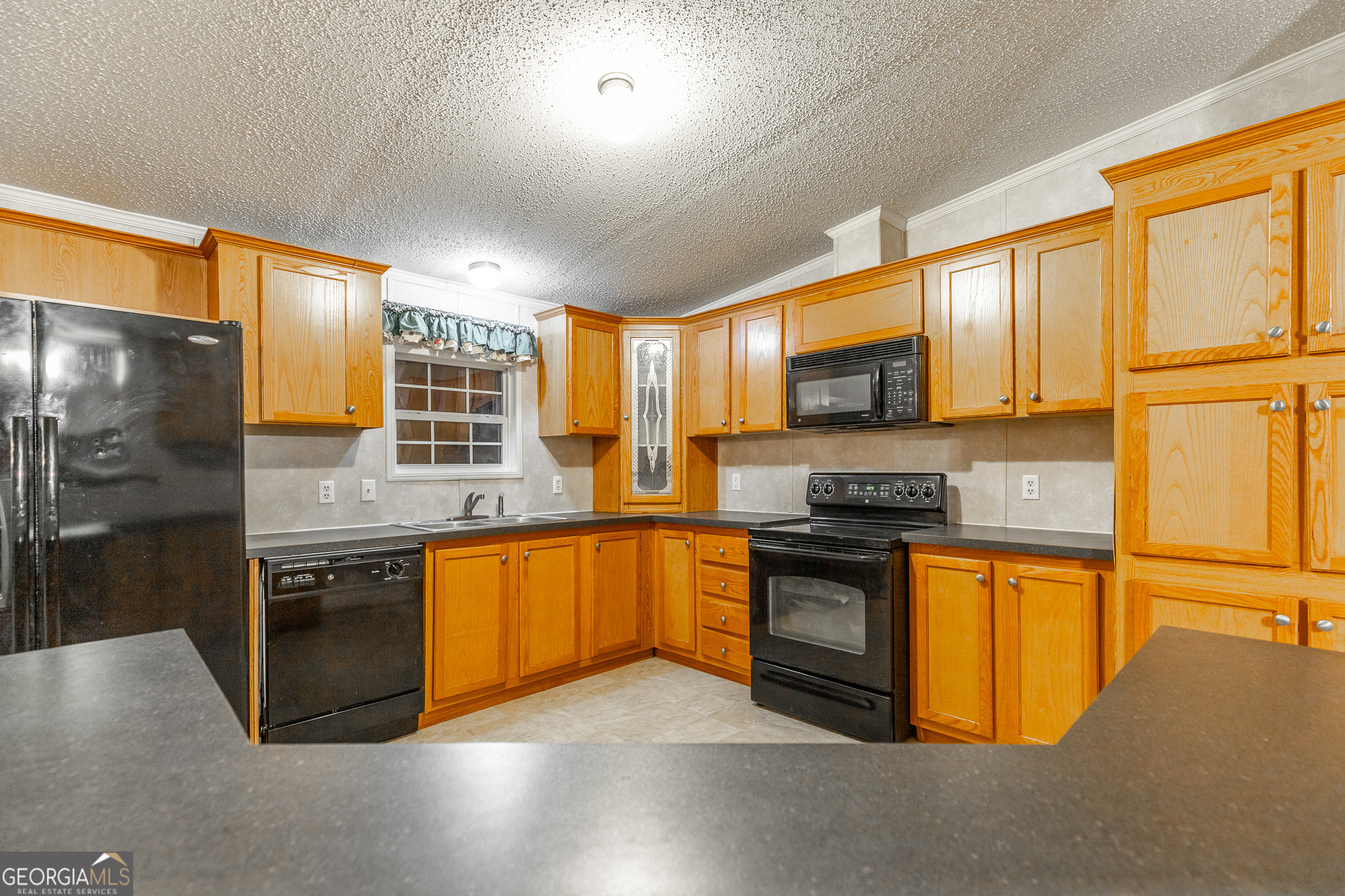 132 Short Hollow Road Trion, GA 30753 - Photo 15 of 46 a kitchen with stainless steel appliances granite countertop a stove a sink and a refrigerator