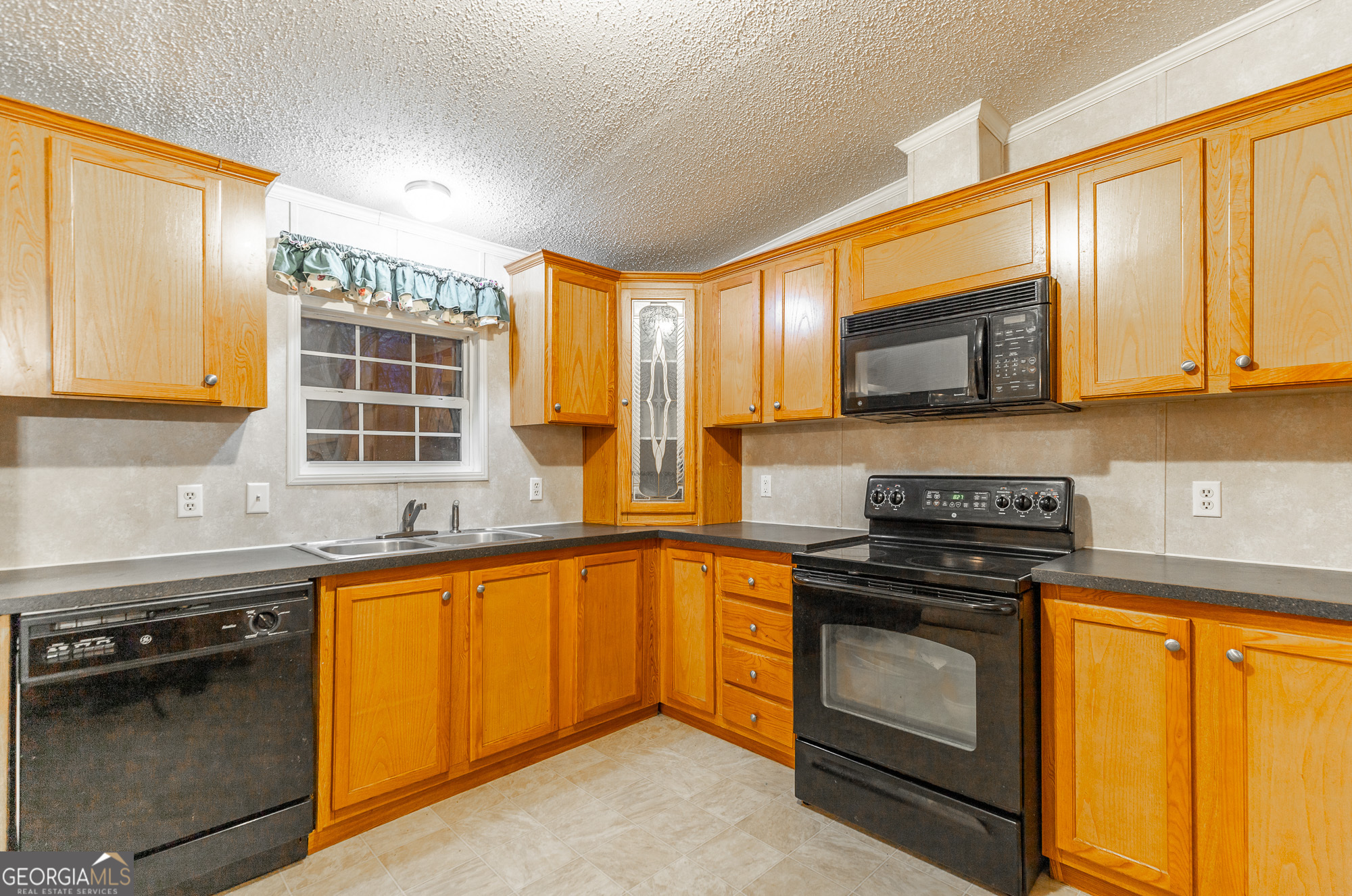 132 Short Hollow Road Trion, GA 30753 - Photo 16 of 46 a kitchen with stainless steel appliances granite countertop wooden cabinets stove and a sink