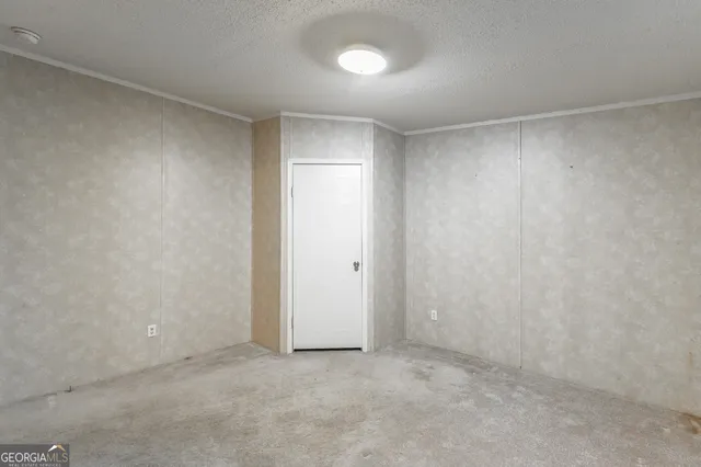 a view of an empty room and a window