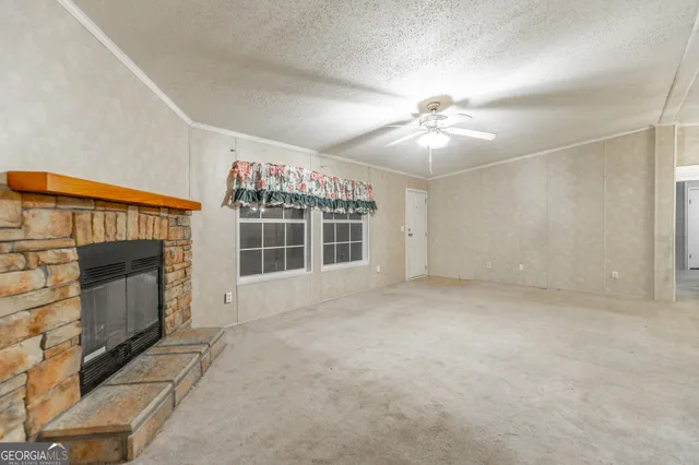 a view of an empty room with a fireplace