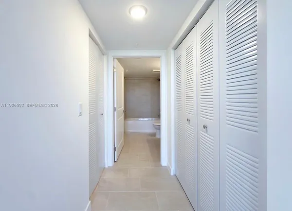 a view of a hallway with a wooden floor