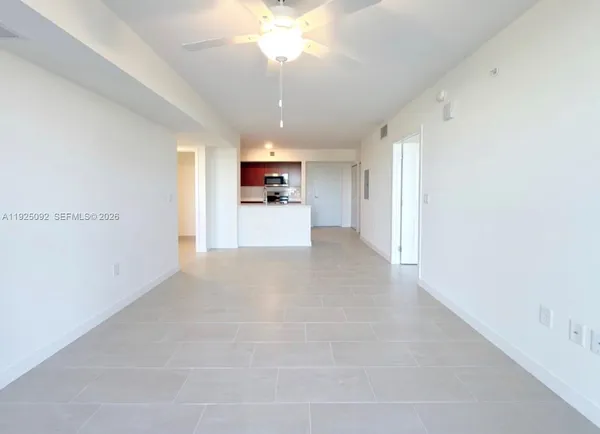 a view of a kitchen with a sink and a chandelier fan